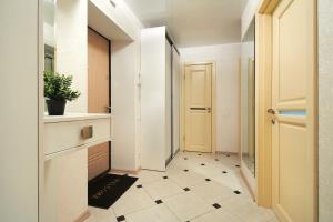 einen Flur mit Tür und Fliesenboden in der Unterkunft PaulMarie Apartments on Kozhara in Homel
