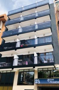 an apartment building with balconies and tables at Rosabel in Benidorm