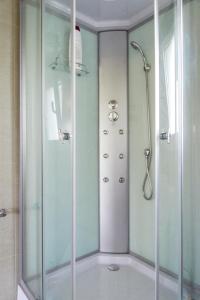 a shower with a glass door in a bathroom at Casa Adofreire in Melgaço +29 photos