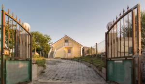 a cobblestone street with a gate and a house at Casa Adofreire in Melgaço