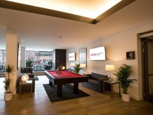 a living room with a pool table in it at DORMERO Hotel Altes Kaufhaus in Lüneburg
