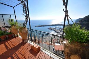 a balcony with a view of the ocean and a harbor at Apartments Cetara in Cetara