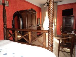 a bedroom with a large mirror and red walls at Hosteria Natura in Segovia