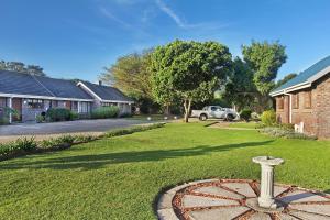 a yard with a stone wheel in the grass at Baywater Village in Sedgefield