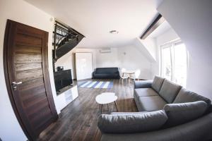 a living room with a couch and a table at Villa Tower Nad Jeziorem Nyskim in Skorochow