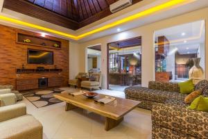 a living room with a couch and a coffee table at Villa Lisha in Canggu