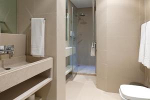 a bathroom with a sink and a shower at Lisbon Serviced Apartments - Baixa in Lisbon +33 photos