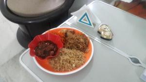 a bowl of food on a plate on a table at Wow Rooms 4 You in Jabalpur