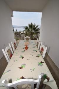 a white table with chairs and a table with birds on it at Apartment Duda in Starigrad