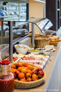 a kitchen counter filled with lots of food at Campanile Leipzig Halle Airport in Leipzig