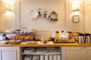 a kitchen with a counter with food on it at Hôtel Montcalm in Paris +61 photos