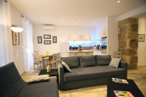 a living room with a couch and a kitchen at Nice Appartement in Nice