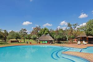 uma grande piscina com um gazebo em Monateng Safari Lodge em Wallmannstal