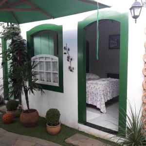 a room with a bed in a house with plants at Pousada Sonho Meu in Paraty