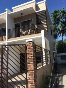 a house with a porch and a balcony at South Prince Residences and Inn in Davao City