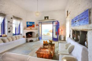KorissiaにあるAmelia Beachfront Villaのリビングルーム(白いソファ、暖炉付)