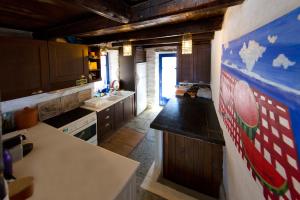 a kitchen with wooden cabinets and a flag on the wall at Amelia Beachfront Villa in Korissia