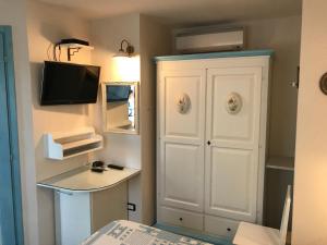 a small room with a white cabinet and a tv at Casale Degli Angeli in Vieste