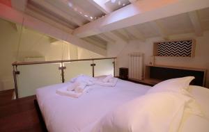 En eller flere senger på et rom på Gonfalone Charming Retreat