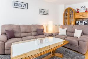 a living room with two couches and a coffee table at Apartments Contessa in Novigrad Istria