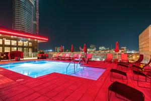 a pool on the rooftop of a building at night at Cambria Hotel Nashville Downtown in Nashville
