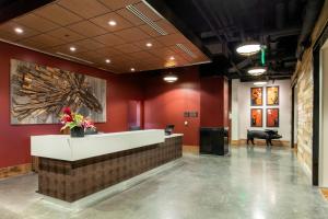 a lobby with a reception desk in a building at Cambria Hotel Nashville Downtown in Nashville