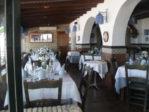 a restaurant with tables with white tablecloths at Casa Francisco el de Siempre in El Palmar