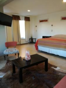 Una cama o camas en una habitación de Hotel Parador Ruta 40