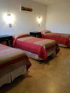 Una cama o camas en una habitación de Hotel Parador Ruta 40