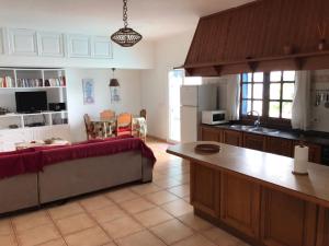 a kitchen with a couch and a table in a room at Casa Beatriz in Famara