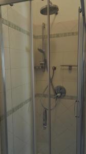 a shower with a glass door in a bathroom at Appartamento Madda in La Maddalena