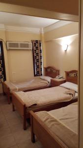Postel nebo postele na pokoji v ubytování Applicators Hotel