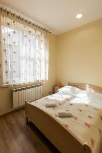 a bedroom with a large bed with flowers on it at Apartamenty Eden in Ustrzyki Dolne