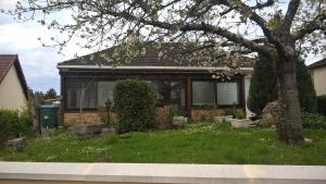 a house with a tree in the yard at chez Myla chambre avec tv écran plat et salle de bain privative in Bourges +9 photos