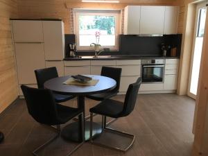 a kitchen with a table and chairs in a kitchen at Ferienhaus Hankel in Hemfurth-Edersee