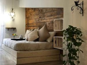 a bedroom with a large bed with a wooden headboard at le Piagge in Viterbo