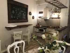 a kitchen with a table and chairs and a chalkboard at le Piagge in Viterbo
