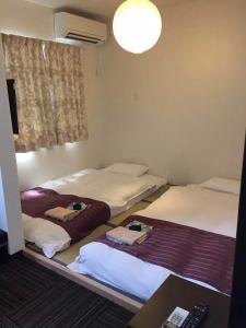 Postel nebo postele na pokoji v ubytování Hotel Sunmarine