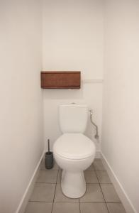 a bathroom with a white toilet in a room at A cozy wooden studio in a heart of Kharkiv in Kharkiv