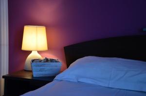 A bed or beds in a room at Ivanovi Apartments