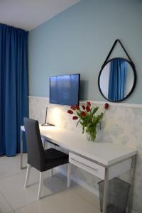 Telewizja i/lub zestaw kina domowego w obiekcie JessApart – Ochota Apartments