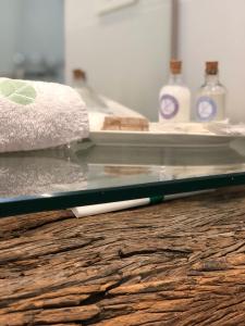 a glass counter top with two bottles of soap at Ciudad Prado Hotel in Córdoba