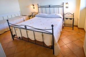 a bedroom with two beds and a tiled floor at Il Glicine in Cetara