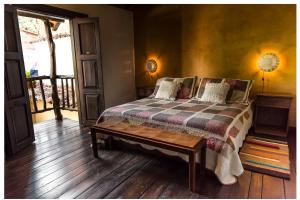 En eller flere senge i et værelse på Hotel Boutique Quinta Tibigaro