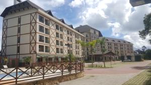 a large building with a fence in front of it at Loft luxo em Pedra Azul in Pedra Azul