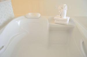 
a white bath tub sitting next to a white toilet at Best Western Plus Wilkes Barre Center City in Wilkes-Barre
