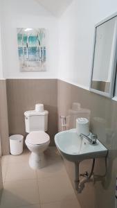 a bathroom with a toilet and a sink at V Resort Dasma in Dasmariñas