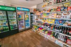 a grocery store aisle with drinks and other products at Badacsony Camping in Badacsonytomaj