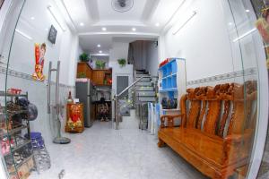 a room with a wooden bench in a room at SƠN THỊNH Guesthouse in Ho Chi Minh City