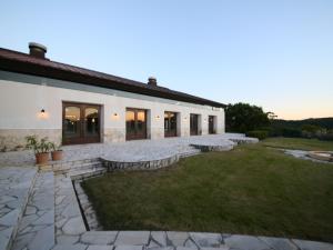 a large white building with a yard in front of it at Southern Cross Resort in Ito